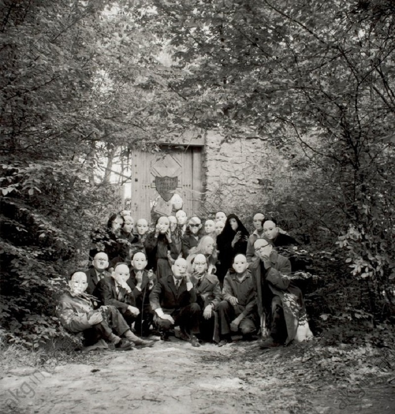 c. 1960. Surrealists wearing masks at a gathering at the Désert de Retz, France (André, Elisa and Aube Breton, G.Goldfayn, Toyen, E.Jaguer, G.Legrand, N.Espagnol, A.Joubert, R. Benayoun, J.Pierre, M.Van Hirtum and others). Group photo, April 1960, by Denise Bellon (1902–1999).
