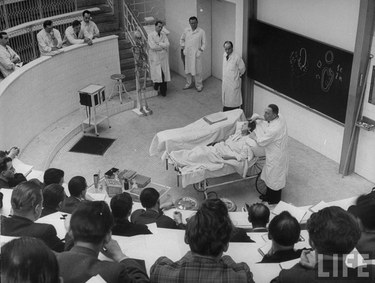 Brain surgeon Arnold Jirasek describing technique of operating on woman with a severely abscessed jaw to medical students from Charles University in amphitheater of his Clinic of Surgery.