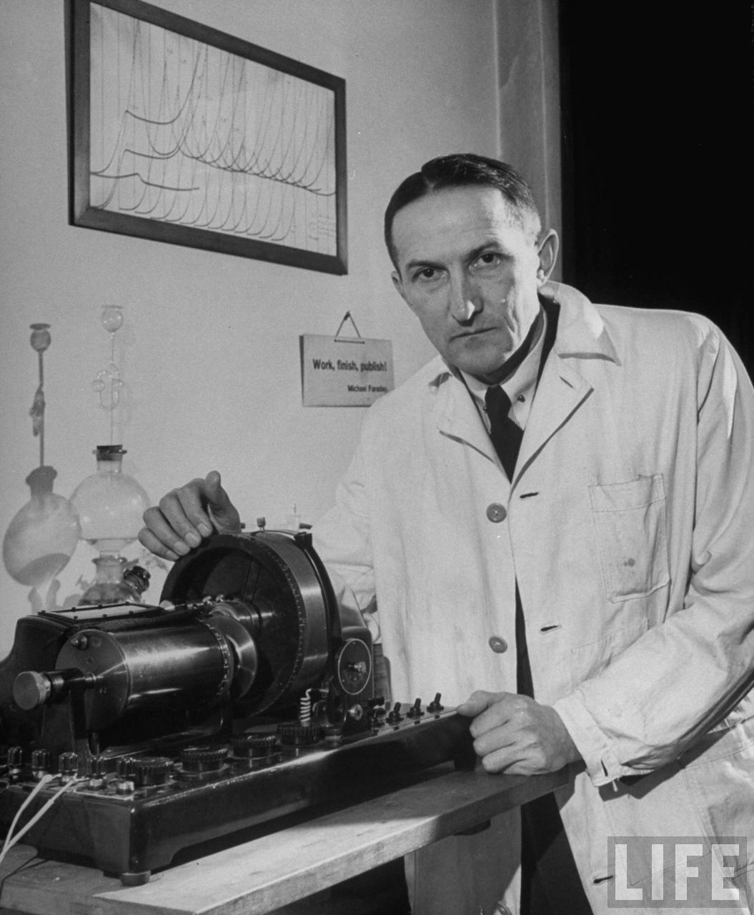 Portrait of Dr. Jaroslav Heyrovsky, head of Physical Chemistry at Charles University, with his invention the polarograph, a device for the microanalysis of various solutions used in medicine, metallurgy, food study and other branches of science. 