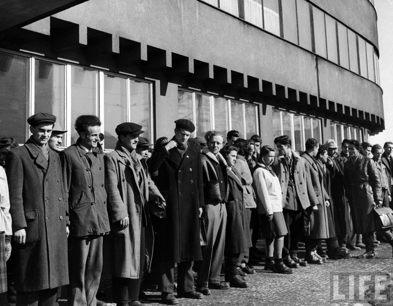 Yugoslavian students at Charles University lining up outside Marshal Tito Hall before going away on weekend to aid in winter coal crisis.