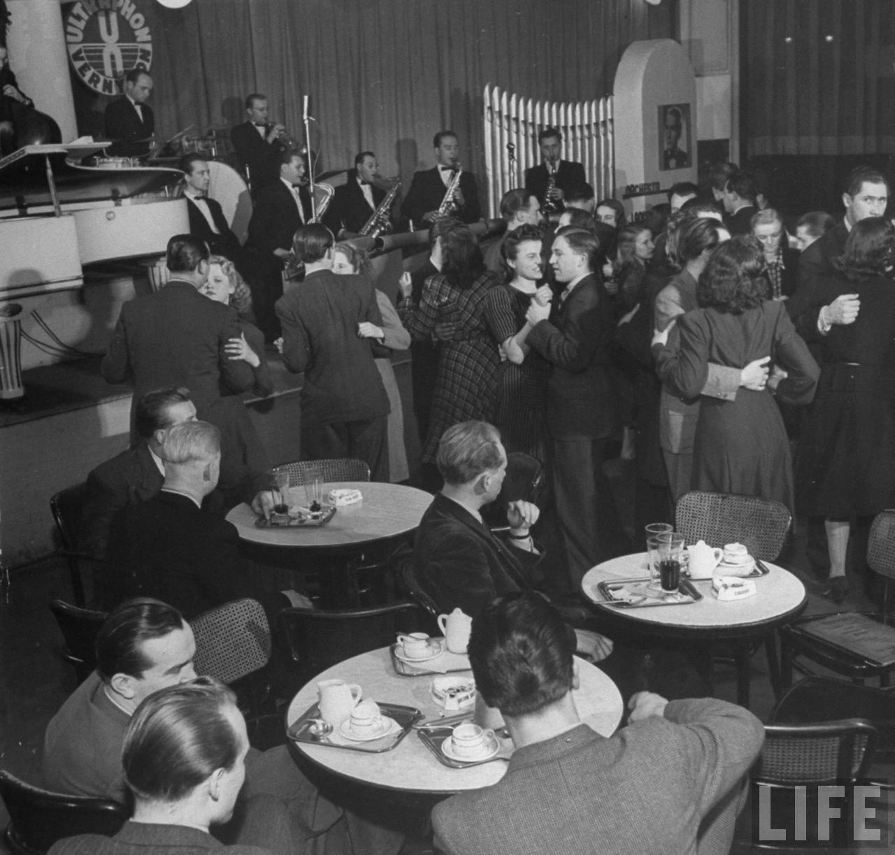 Charles University students at coffee house drinking coffee and lemonade and dancing to swing band.