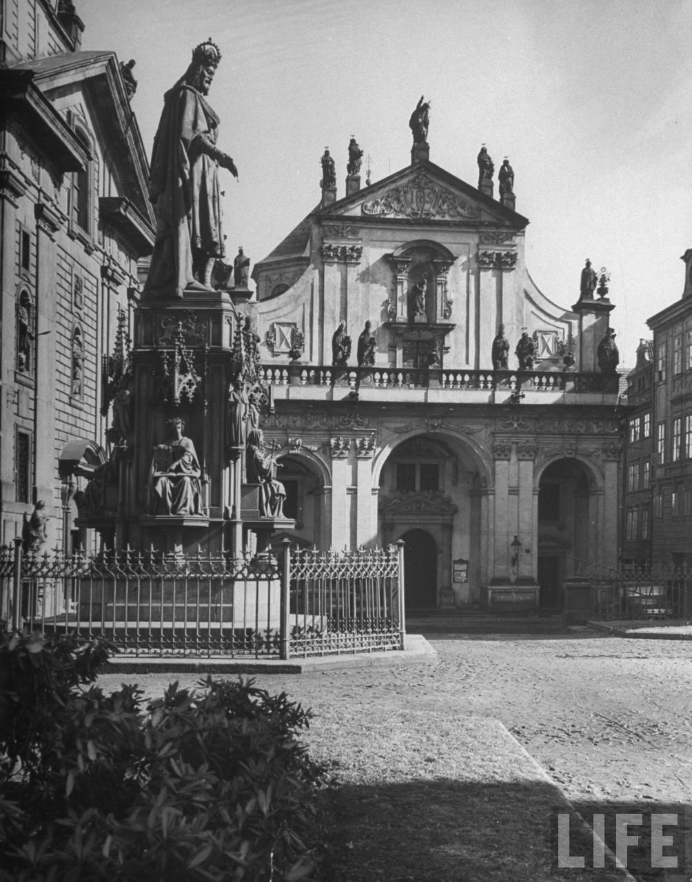 Statue of King Charles IV (L); in the bkgrd. is Clementinum, former Jesuit College which now houses the Charles University library.