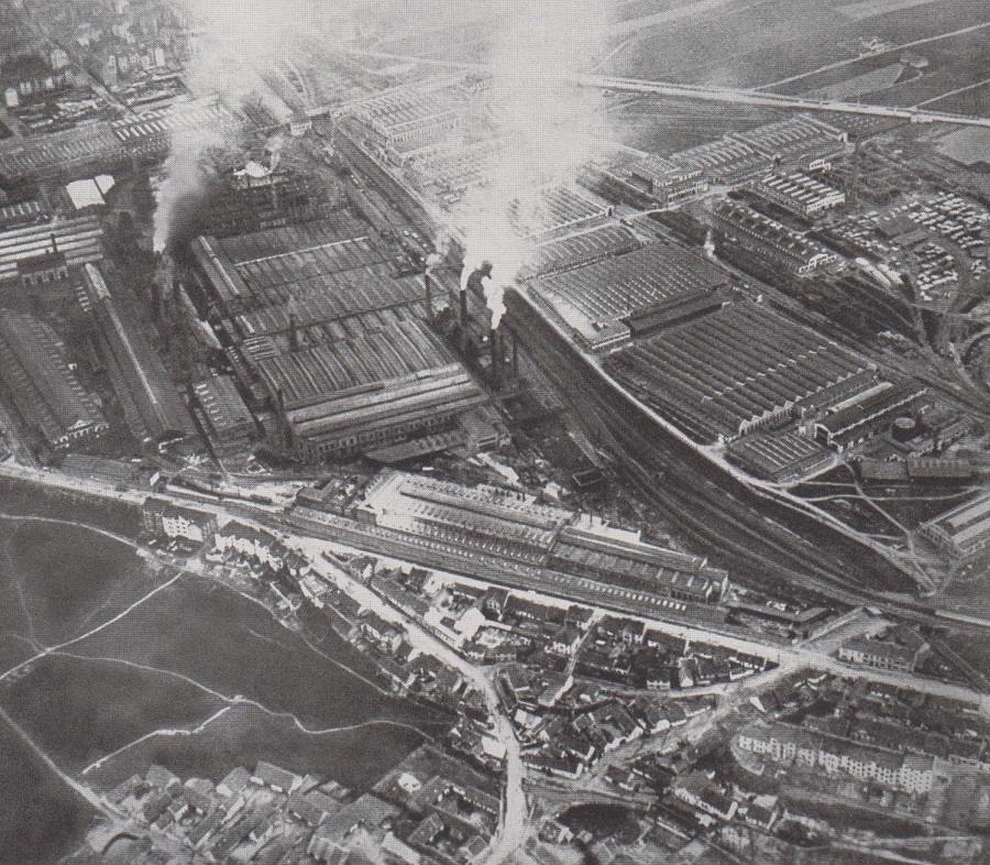 BEHIND THE CZECHOSLOVAK ARMY IS THE GIGANTIC SKODA FACTORY.