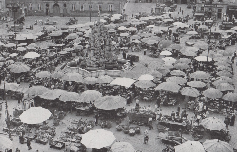 HUNGRY HUNDREDS THRONG THE KRAUT MARKET BELOW MARIA JERITZA'S WINDOW IN BRNO. 