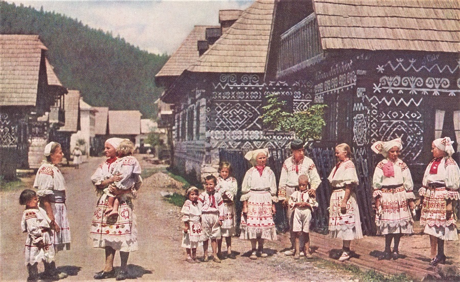 AFTER DESTRUCTION BY FIRE IN 1921, VILLAGE HOUSES WERE REBUILT OF DOVETAILED LOGS IN THE OLD-TIME MANNER.