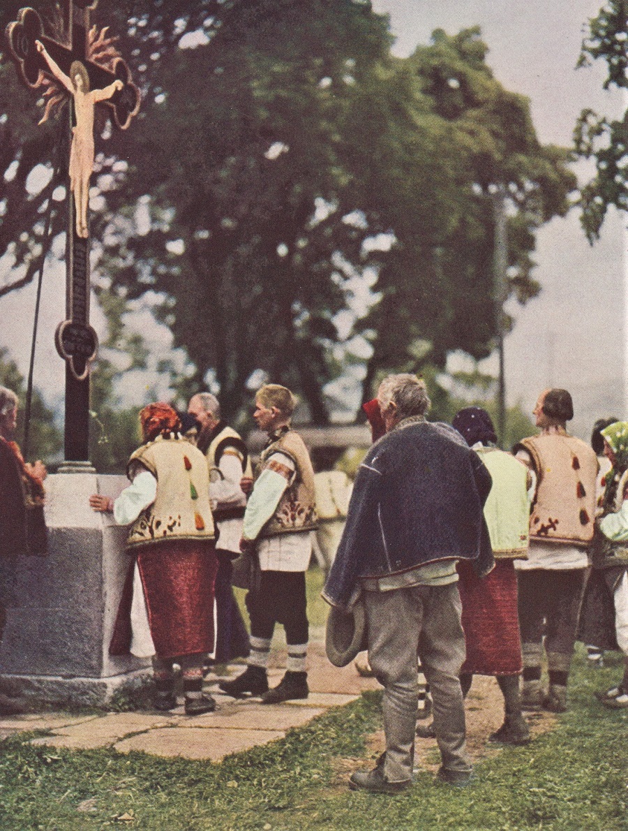 OUTSIDE THEIR CHURCH, HUCULS KISS THE CROSS. 