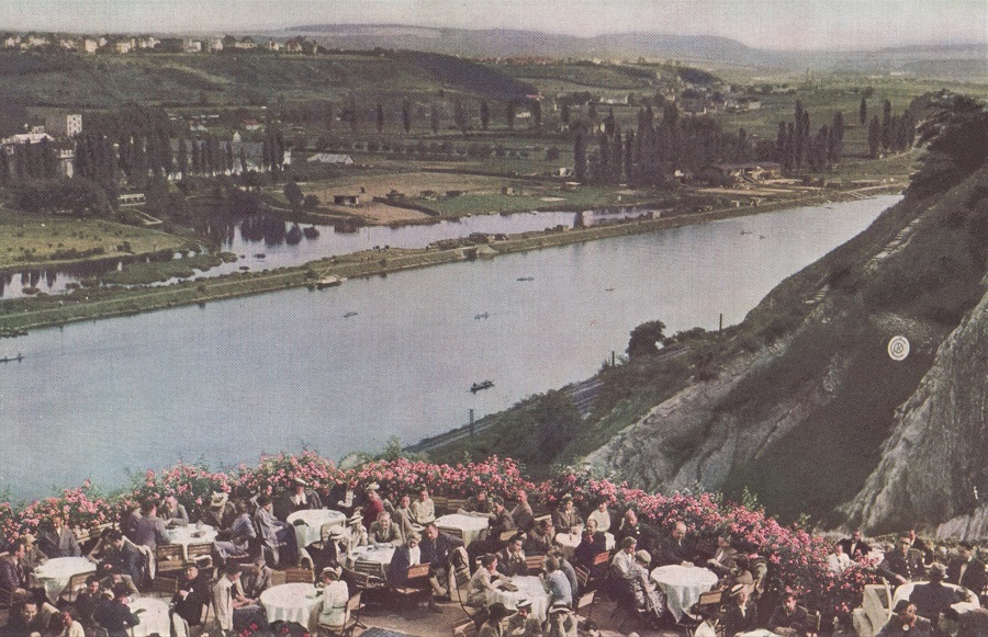SIDE-WHEELERS FLYING THE VLTAVA. BRING HOLIDAY CROWDS FROM PRAHA TO THE ROSE-FRINGED TERRACES OF BARRANDOV.
